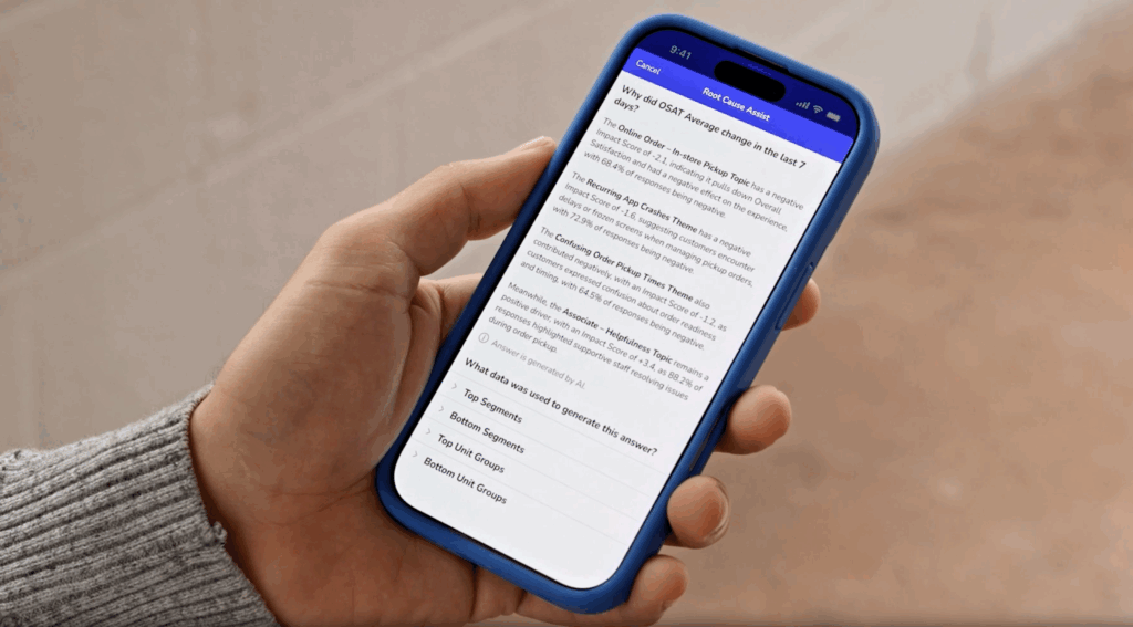 A hand holds a blue-cased smartphone displaying a FAQ page with the heading “Why did GREAT change in the last 7 days?” and several sections of explanatory text on the screen.